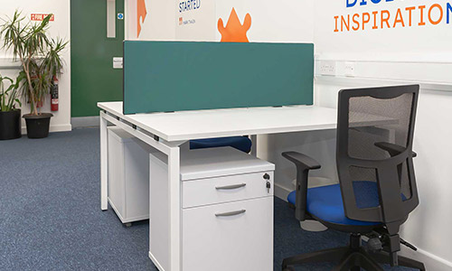 Dedicated desk with operator chair and lockable pedestal in a communal workspace in Balbriggan